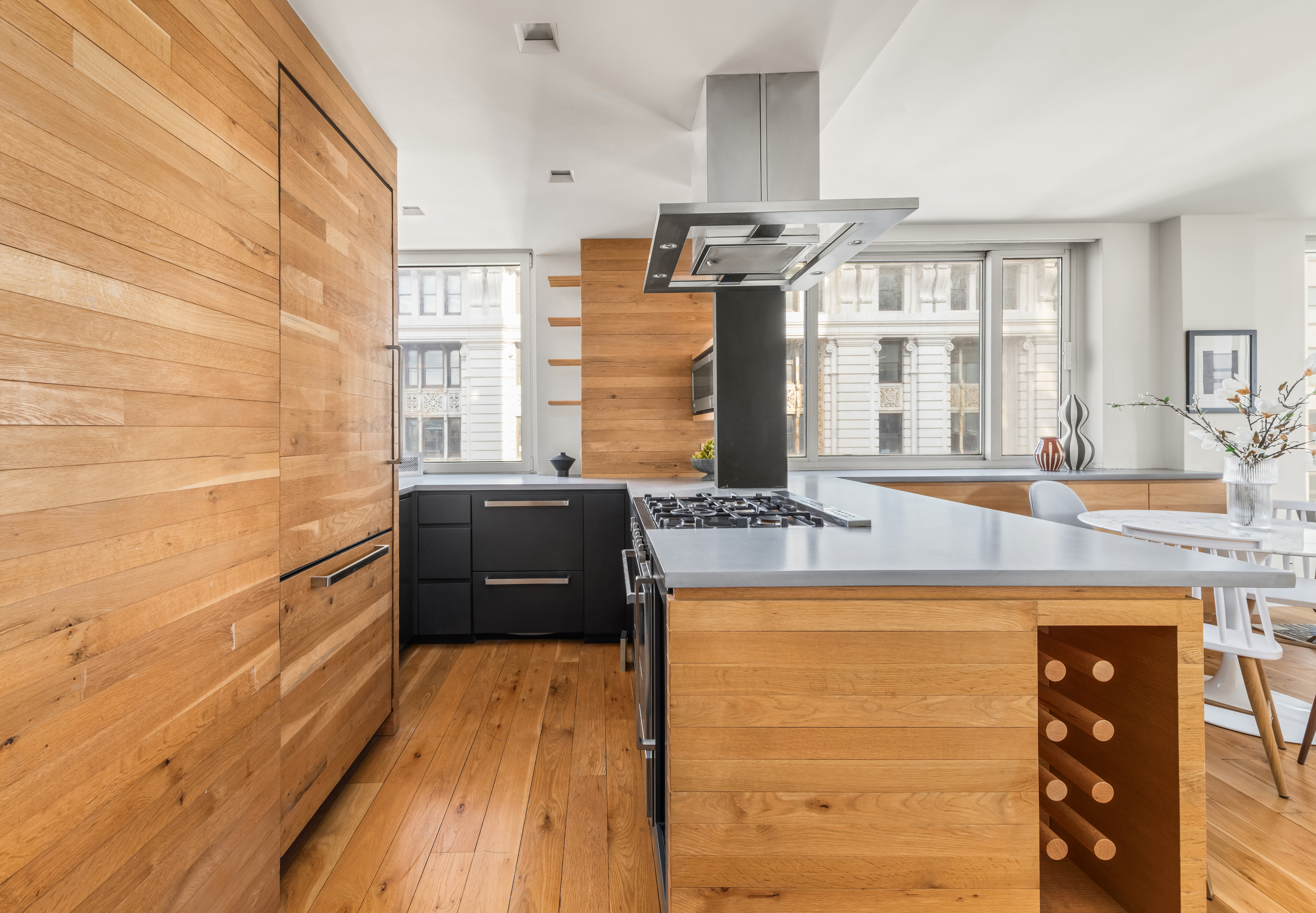 1 Irving Place, Unit G20A Manhattan, NY 10003 - Photo 4 of 14 a kitchen with stainless steel appliances granite countertop a sink and wooden cabinets