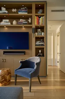 a room with a bookshelf and a flat screen tv