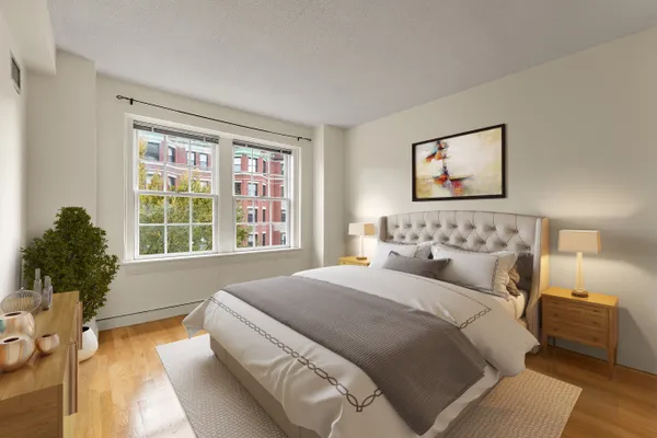 a bedroom with bed and a large window