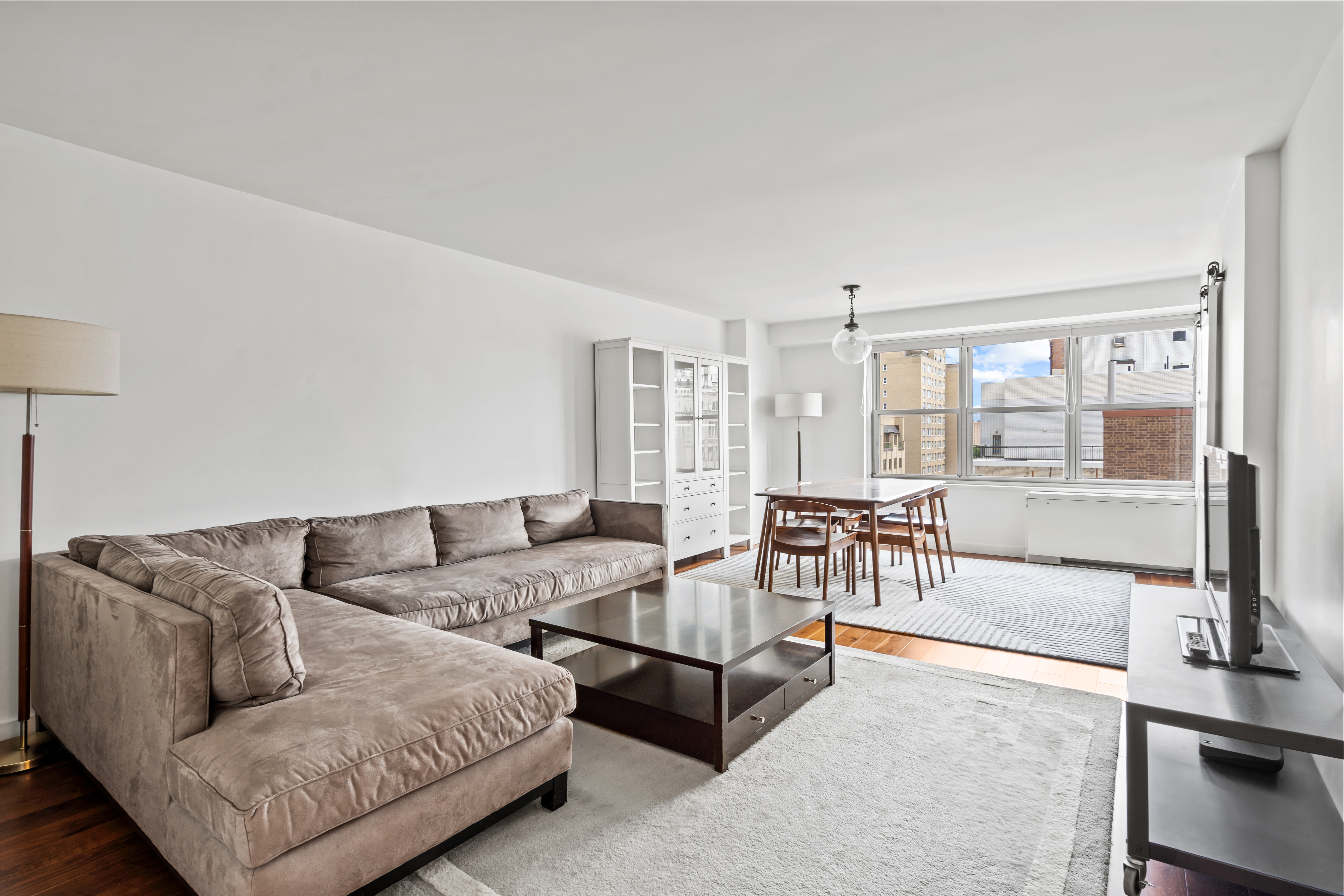 205 3rd Avenue, Unit 11T Manhattan, NY 10003 - Photo 2 of 20 a living room with furniture and a large window