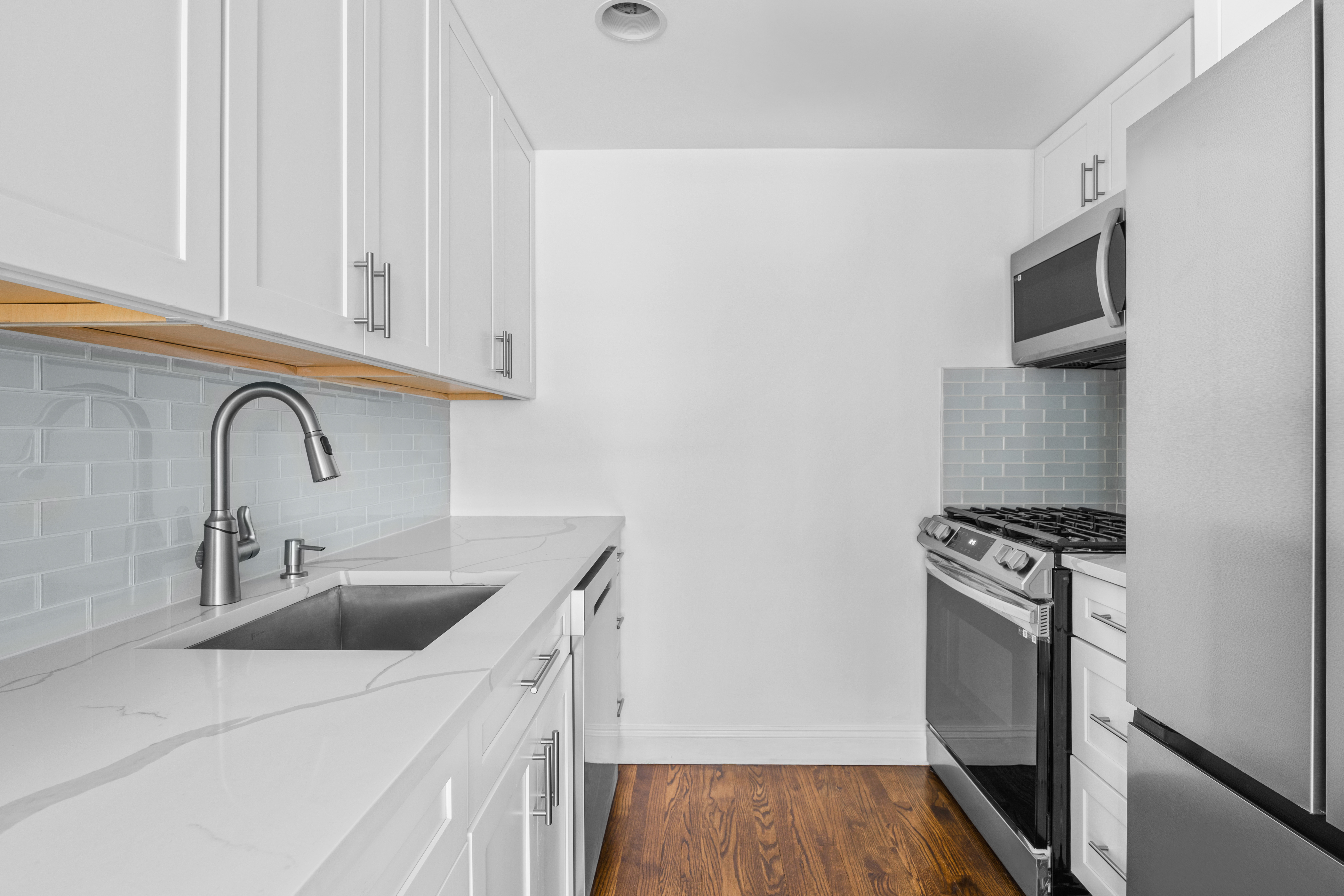 125 Bergen Street, Unit 1A Brooklyn, NY 11201 - Photo 4 of 9 a kitchen with a sink stove and microwave