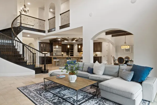a living room with furniture a floor to ceiling window and a flat screen tv