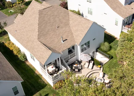 an aerial view of a house with backyard