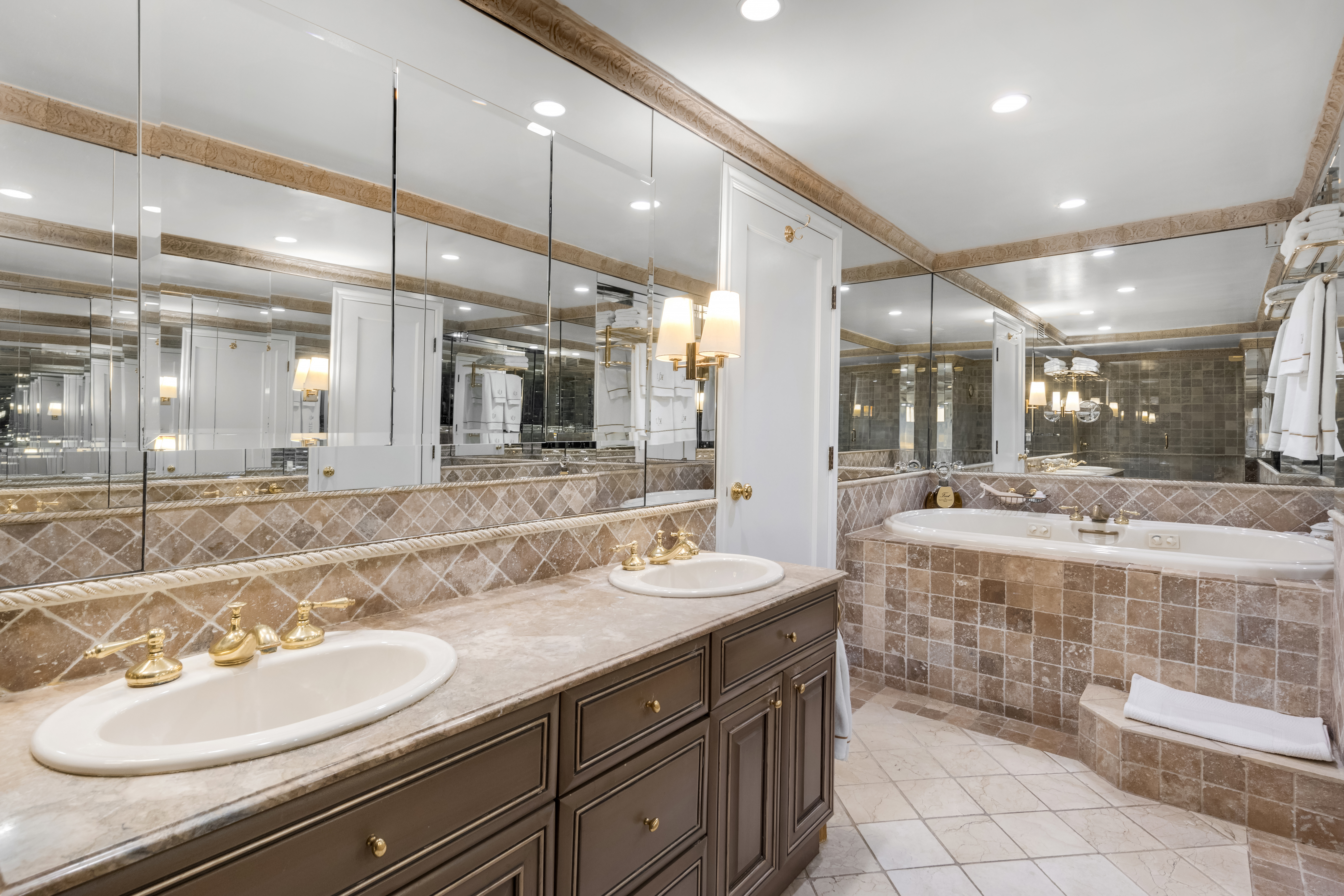 27 East 65th Street, Unit 10BC Manhattan, NY 10065 - Photo 7 of 16 a bathroom with a sink double vanity and a mirror