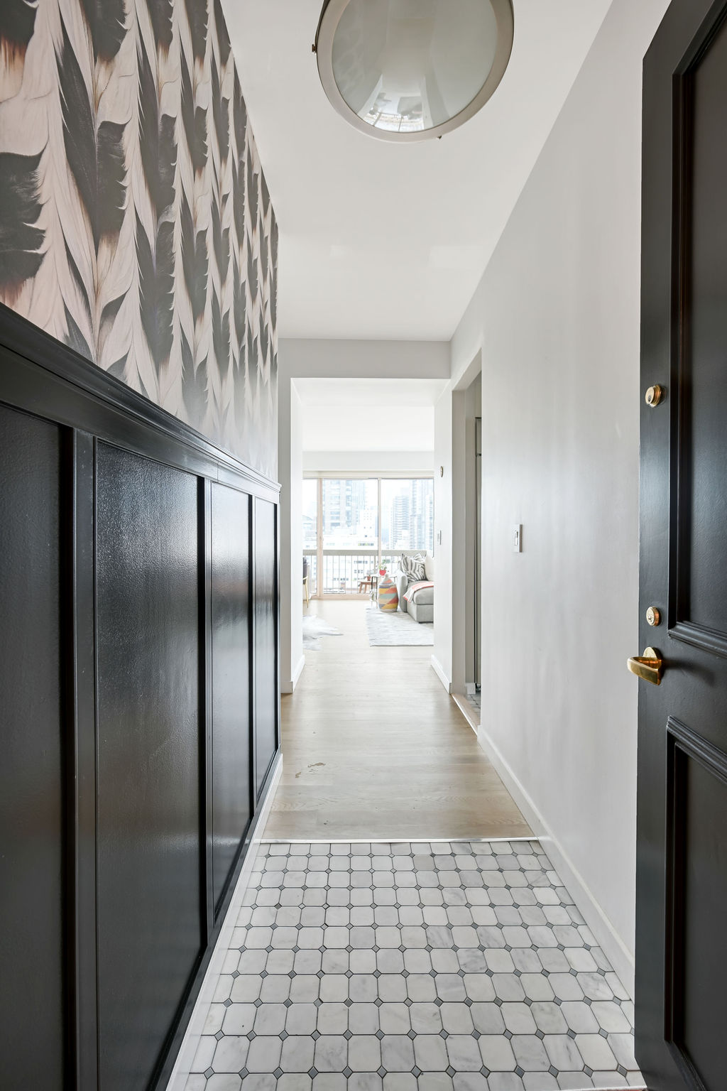 200 East 69th Street, Unit 21C Manhattan, NY 10021 - Photo 9 of 16 a view of a hallway with wooden floor and a living room