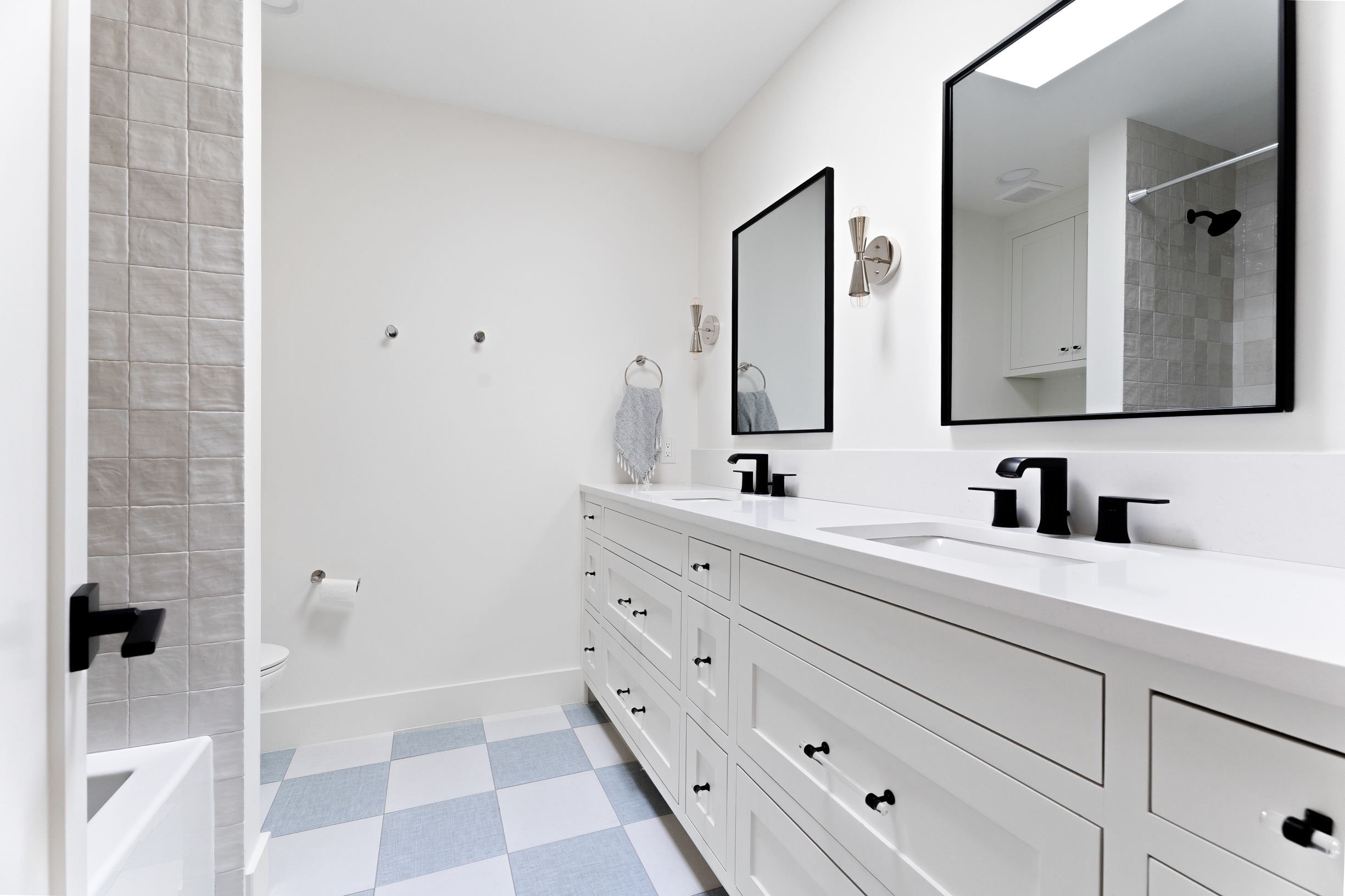 1317 Thaddeus Cove Austin, TX 78746 - Photo 15 of 22 a bathroom with a double vanity sink a mirror and a shower