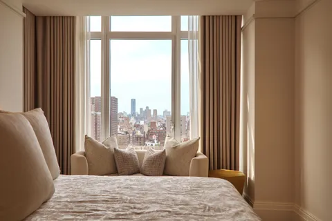 a view of livingroom with furniture and large windows