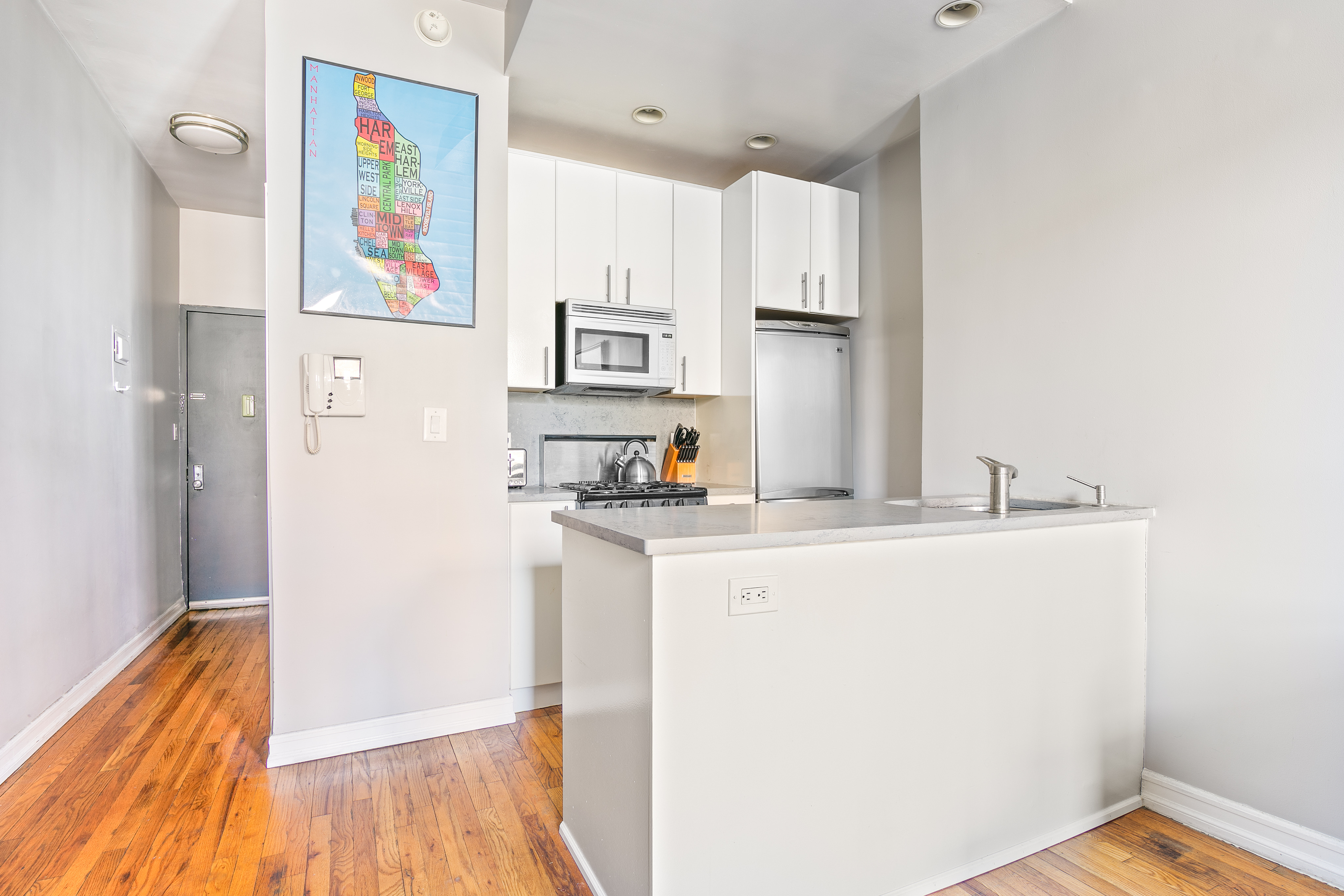 237 East 88th Street, Unit 401 Manhattan, NY 10128 - Photo 2 of 7 a kitchen with stainless steel appliances granite countertop a refrigerator and a stove top oven