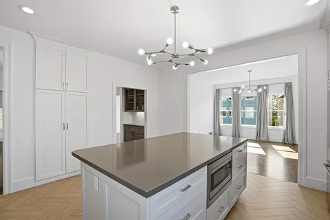 a kitchen with stainless steel appliances granite countertop a sink a stove and a refrigerator