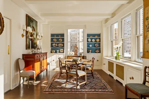 a dining room with furniture and wooden floor