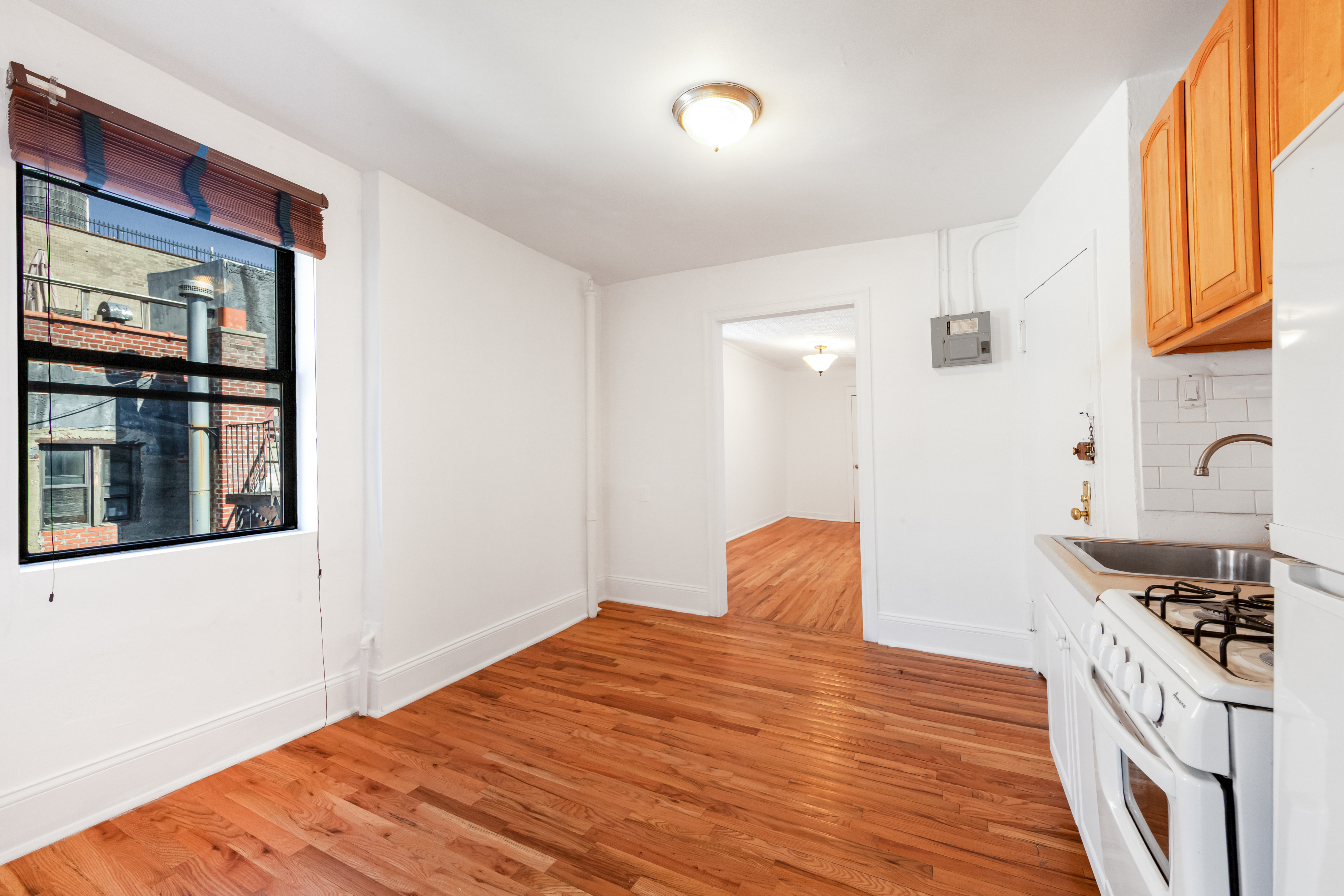 241 Mulberry Street, Unit 21 Manhattan, NY 10012 - Photo 5 of 5 a bedroom with a bed and wooden floor