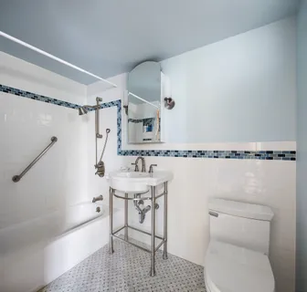 a bathroom with a toilet a sink and a shower