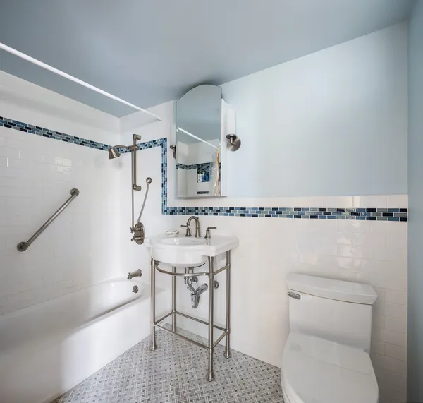 a bathroom with a toilet a sink and a shower