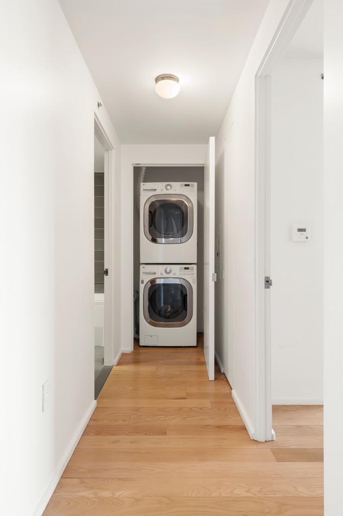 2280 Frederick Douglass Boulevard, Unit 6A Manhattan, NY 10027 - Photo 8 of 13 a view of a hallway with washer and dryer