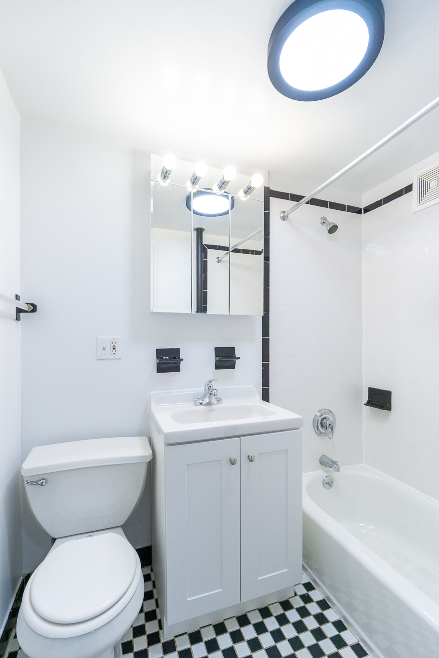 337 East 6th Street, Unit 9 Manhattan, NY 10003 - Photo 10 of 15 a bathroom with a sink a toilet and a mirror