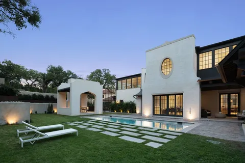 a backyard of a house with table and chairs