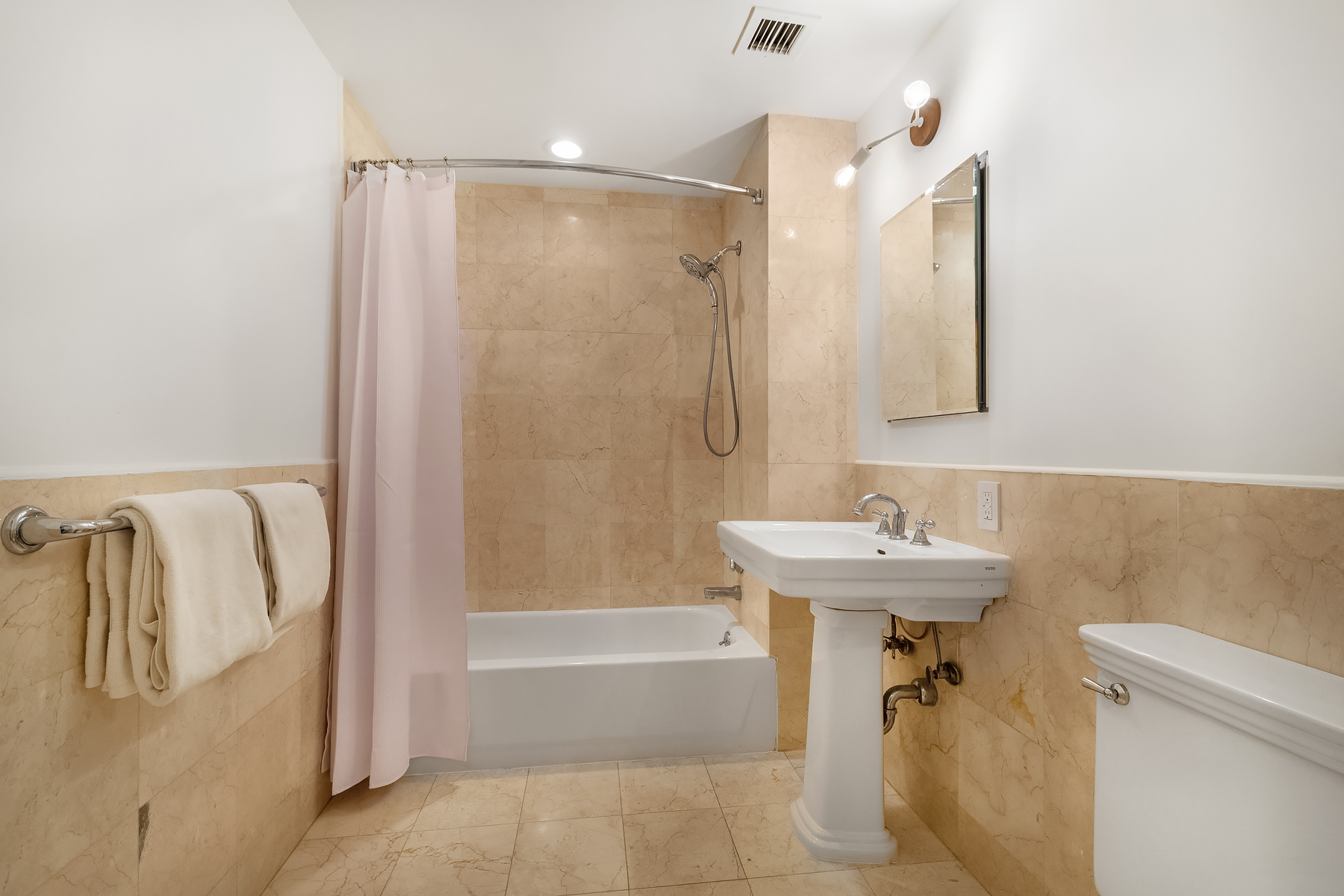 163 St Nicholas Avenue, Unit PH7A Manhattan, NY 10026 - Photo 5 of 11 a bathroom with a sink a toilet and shower