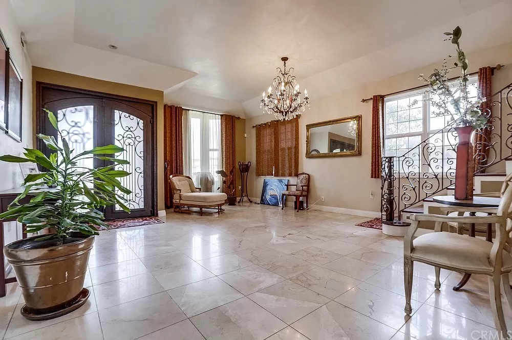 15604 Deblynn Avenue Gardena, CA 90248 - Photo 14 of 22 a living room with furniture and a chandelier