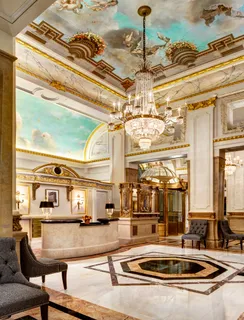 a living room with lots of furniture and chandelier