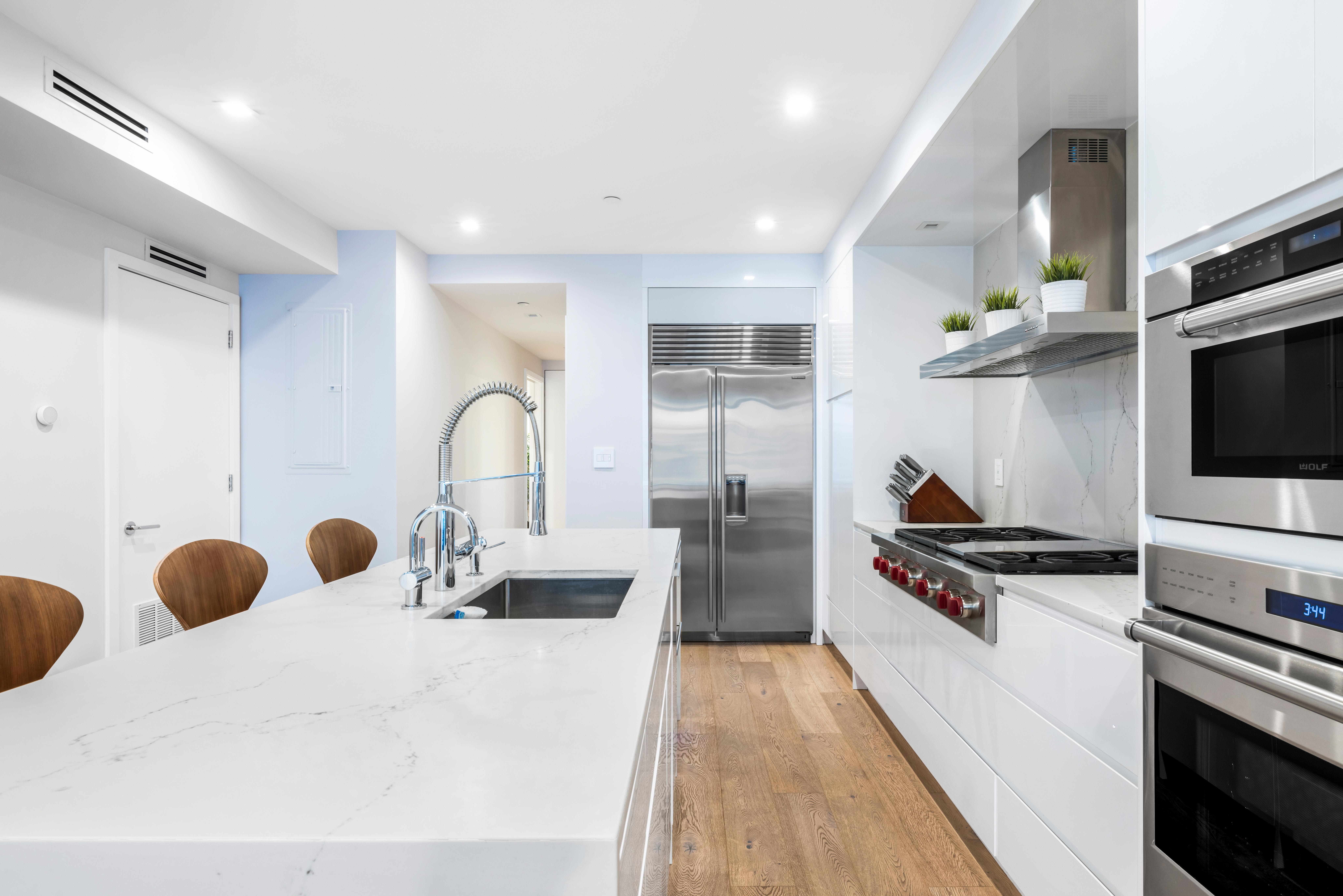 17 East 17th Street, Unit 4 Manhattan, NY 10003 - Photo 6 of 11 a kitchen with stainless steel appliances a stove a sink and a refrigerator