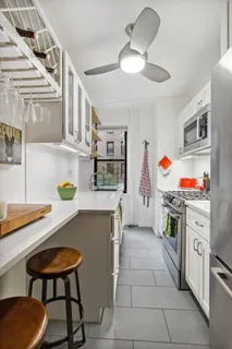 a kitchen with stainless steel appliances a stove a sink and a refrigerator