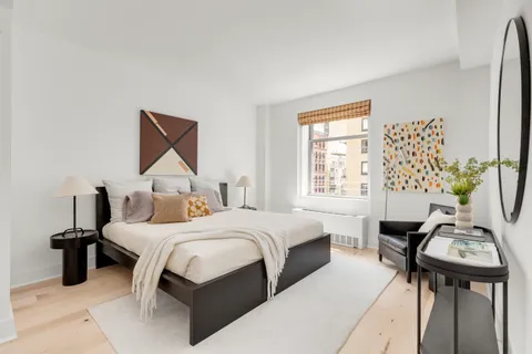 a bedroom with a bed and a table