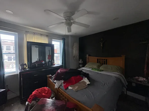 a bedroom with a bed and window