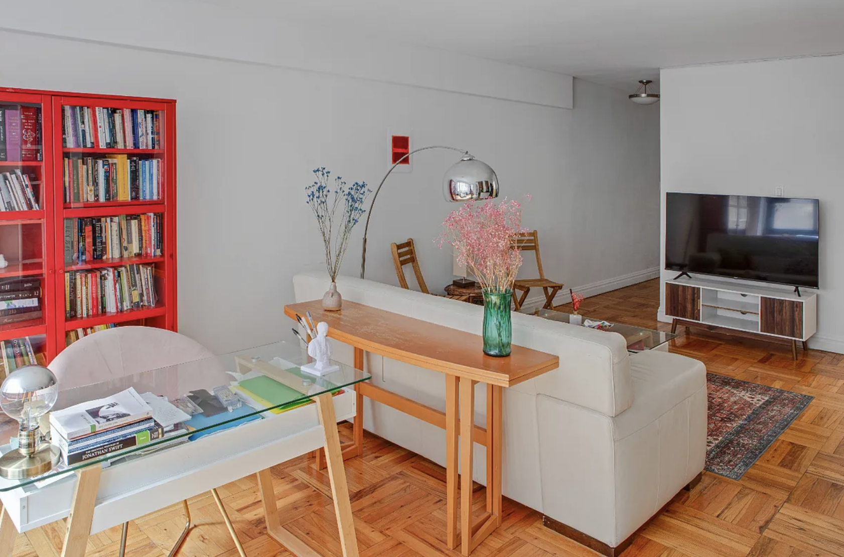 420 East 64th Street, Unit E7K Manhattan, NY 10065 - Photo 3 of 10 a living room with furniture and a flat screen tv