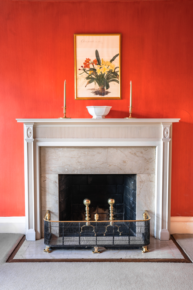 1220 Park Avenue, Unit 12B Manhattan, NY 10128 - Photo 5 of 12 a fireplace with a vase on top of it
