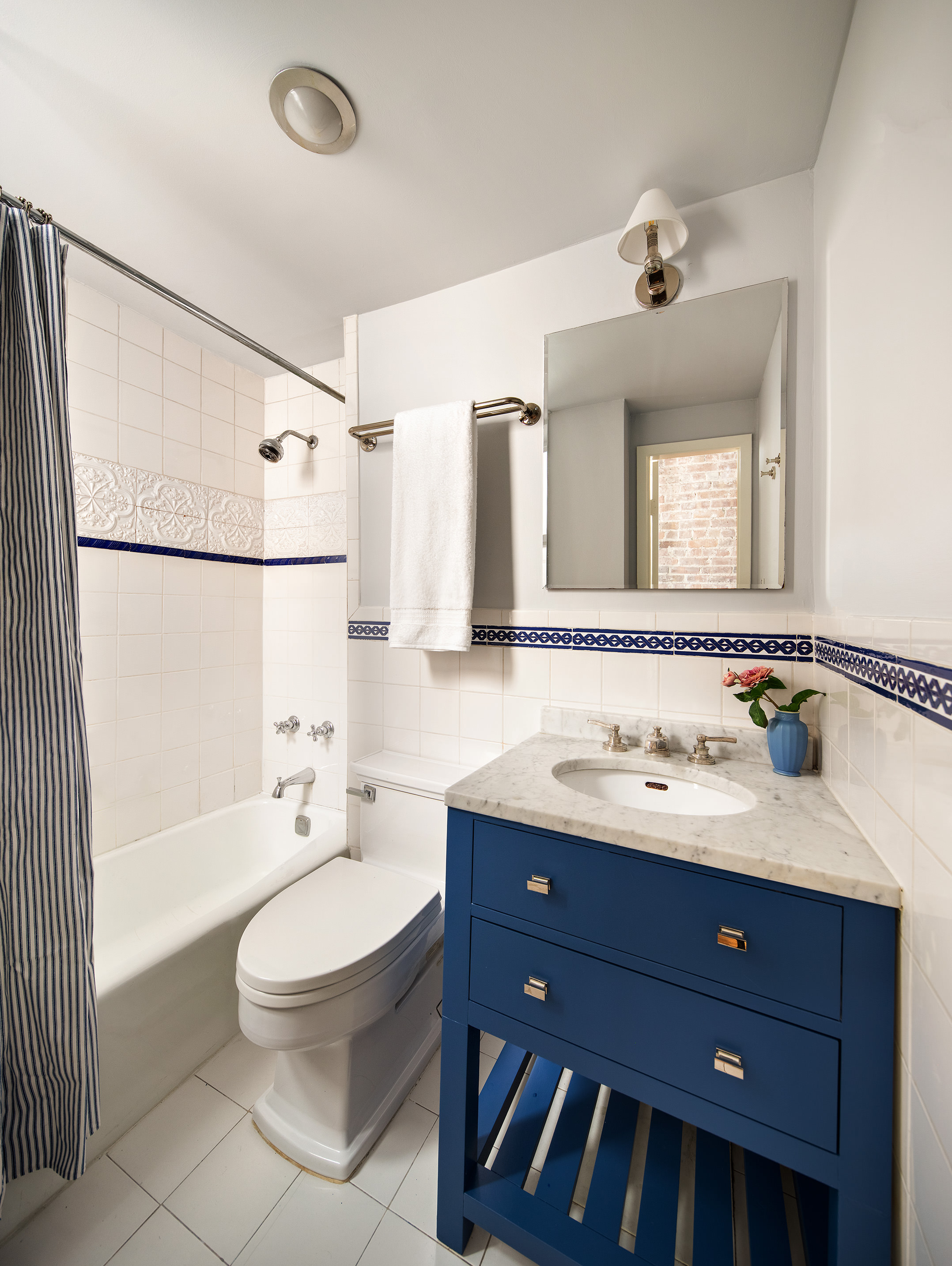 53 West 11th Street, Unit 4W Manhattan, NY 10011 - Photo 6 of 8 a bathroom with a toilet sink double vanity and mirror