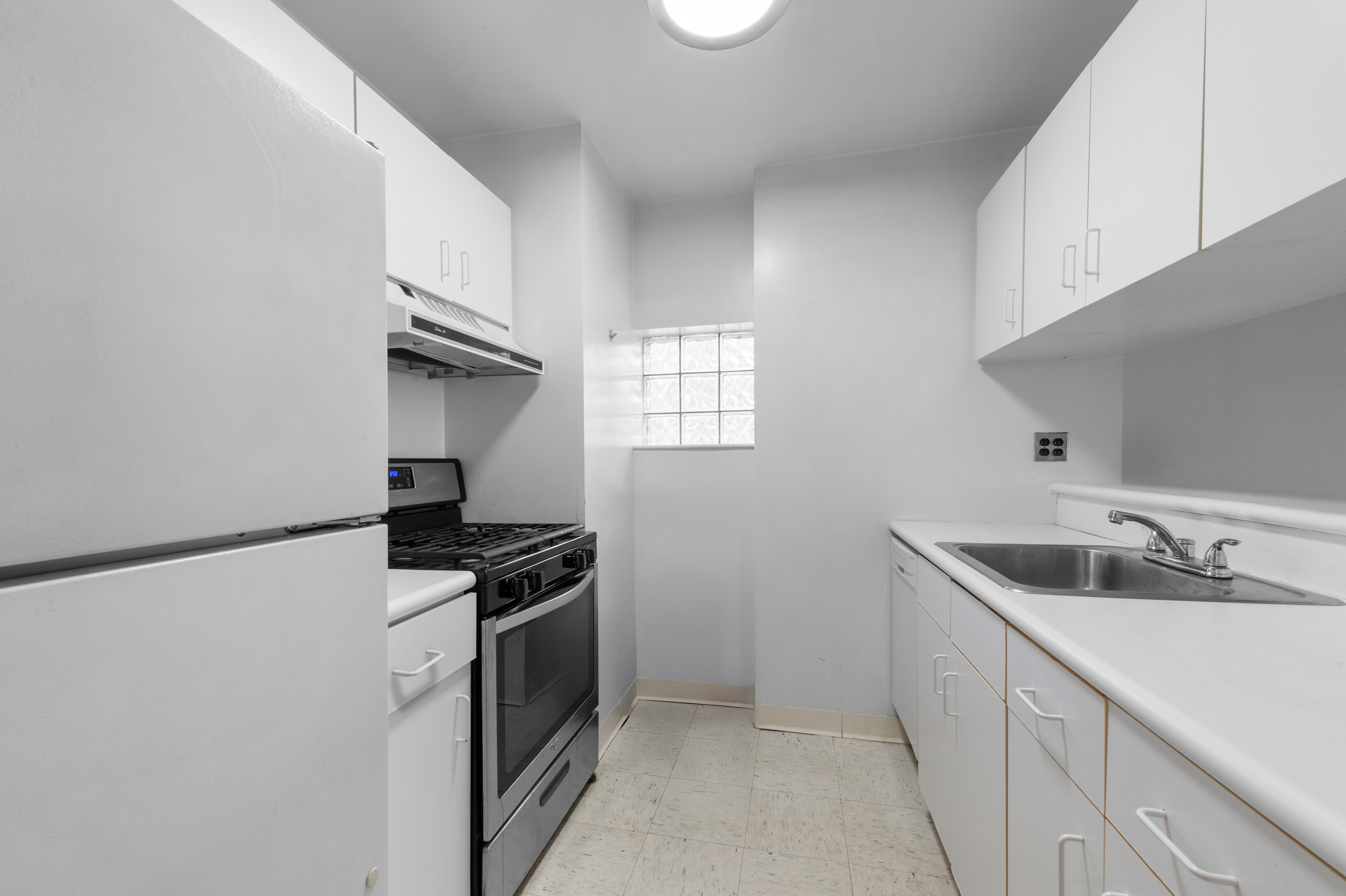 376 Broadway, Unit 24G Manhattan, NY 10013 - Photo 5 of 8 a kitchen with a sink and cabinets