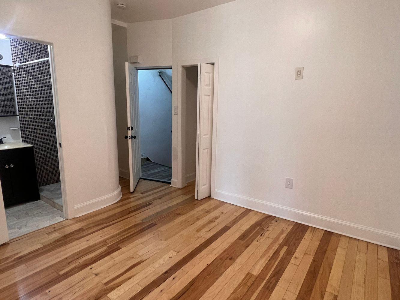 1218 Nostrand Avenue, Unit 1 Brooklyn, NY 11225 - Photo 3 of 5 a view of a room with wooden floor and bench