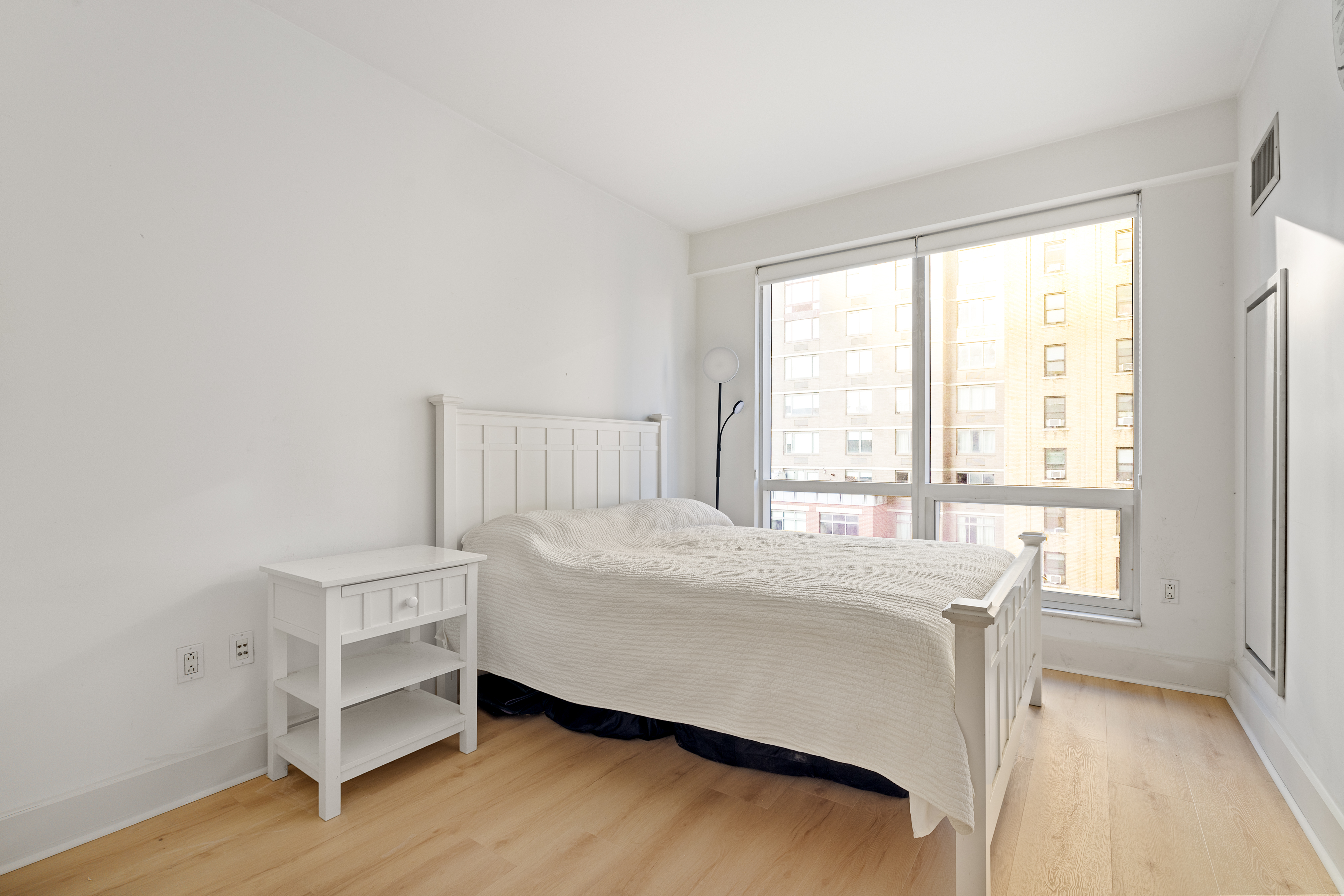 350 West 42nd Street, Unit 5D Manhattan, NY 10036 - Photo 3 of 13 a bedroom with a bed and a window