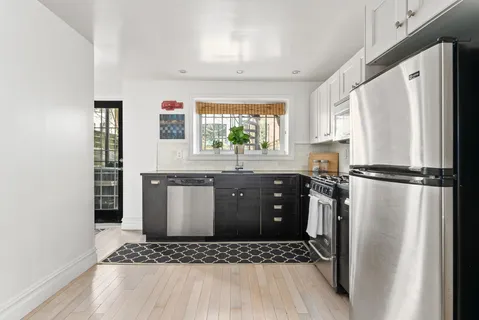 a kitchen with stainless steel appliances granite countertop a refrigerator a stove a sink and a microwave