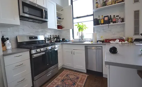 a kitchen with cabinets appliances and a sink