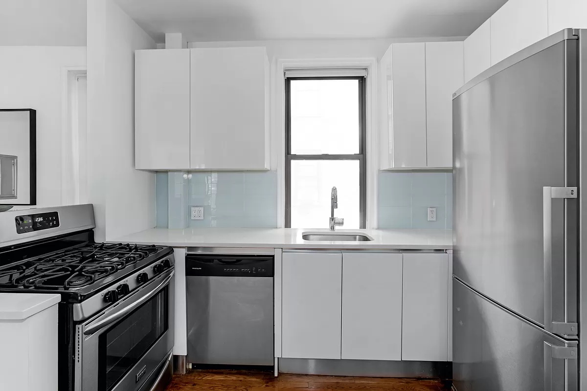 245 West 25th Street, Unit 2C Manhattan, NY 10001 - Photo 2 of 13 a kitchen with a stove a refrigerator and a sink