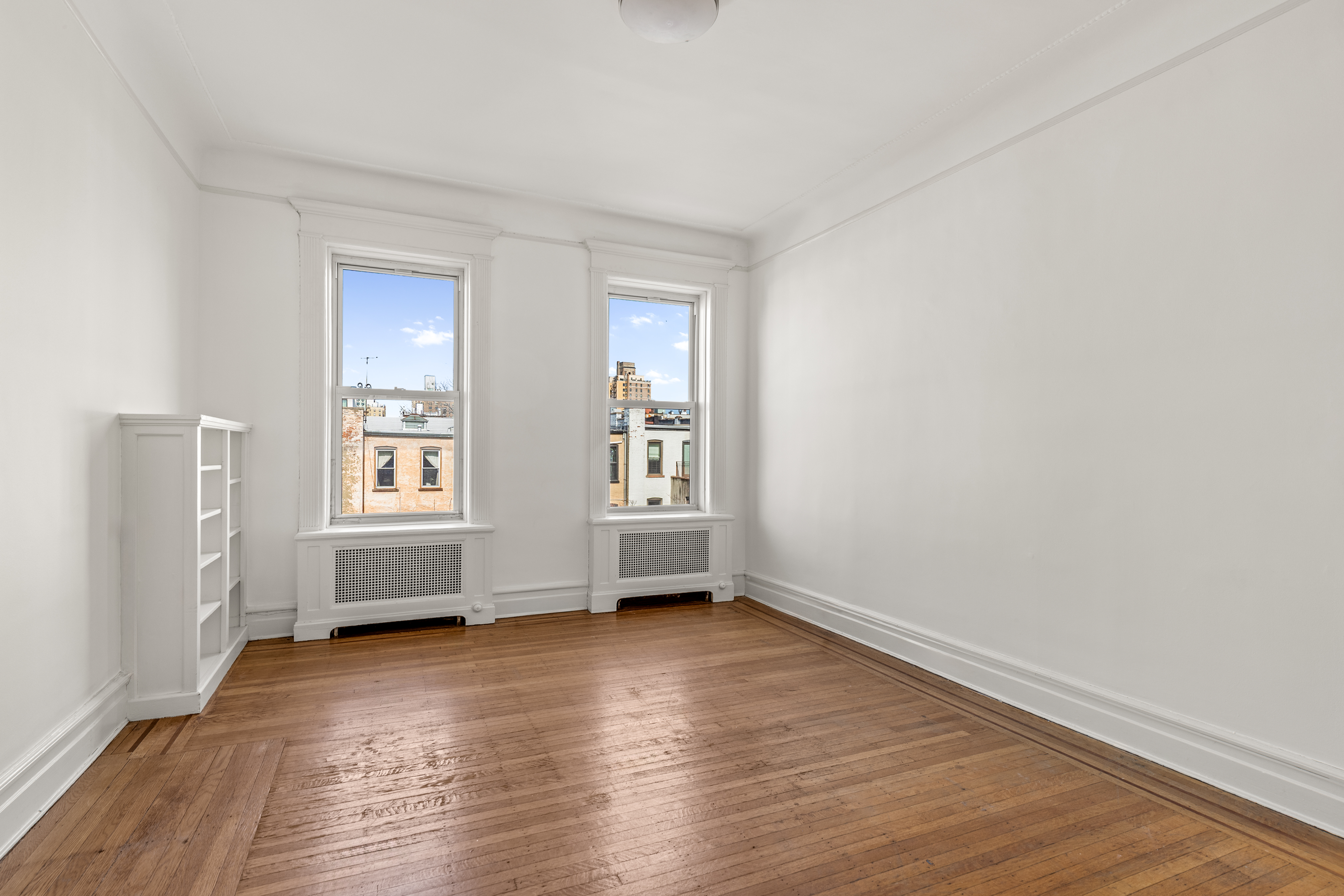 599 2nd Street Brooklyn, NY 11215 - Photo 12 of 16 an empty room with wooden floor and windows
