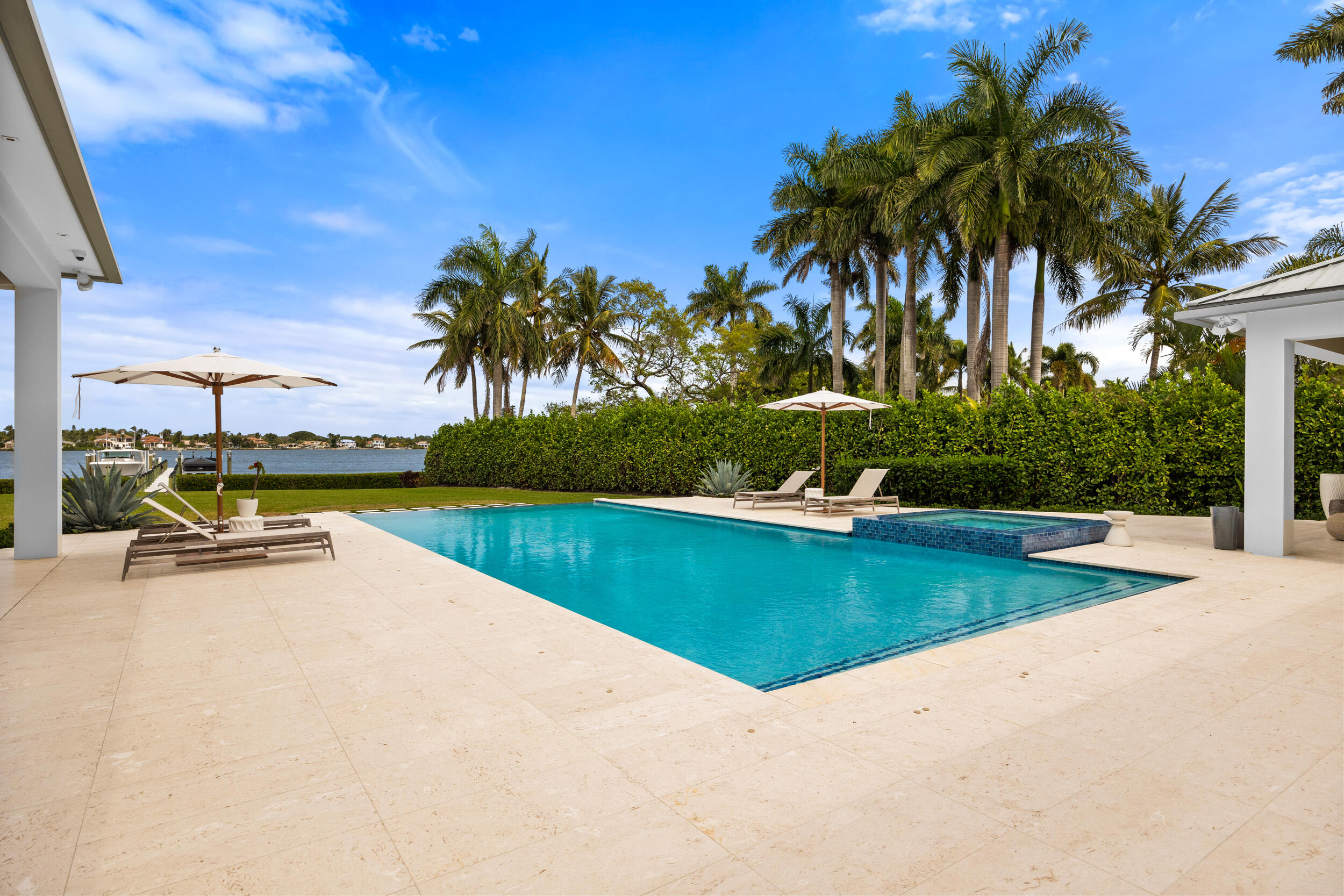 5695 Pennock Point Road Jupiter, FL 33458 - Photo 11 of 77 a view of a swimming pool and lounge chair