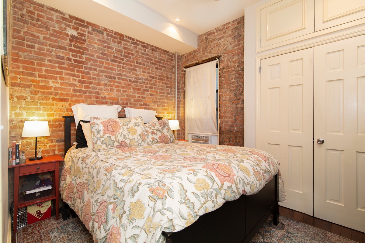 445 Rogers Avenue, Unit 1LF Brooklyn, NY 11225 - Photo 4 of 6 a large bed sitting in a bedroom next to a window