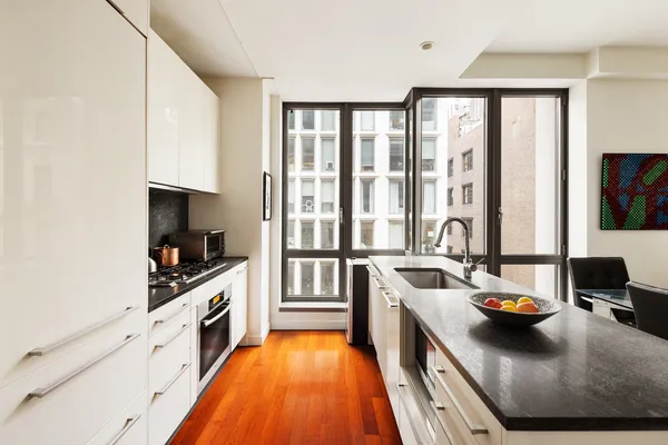 a kitchen with stainless steel appliances a stove a sink and a refrigerator