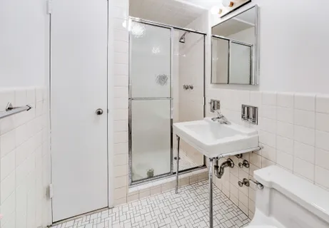 a bathroom with a sink a mirror and a shower