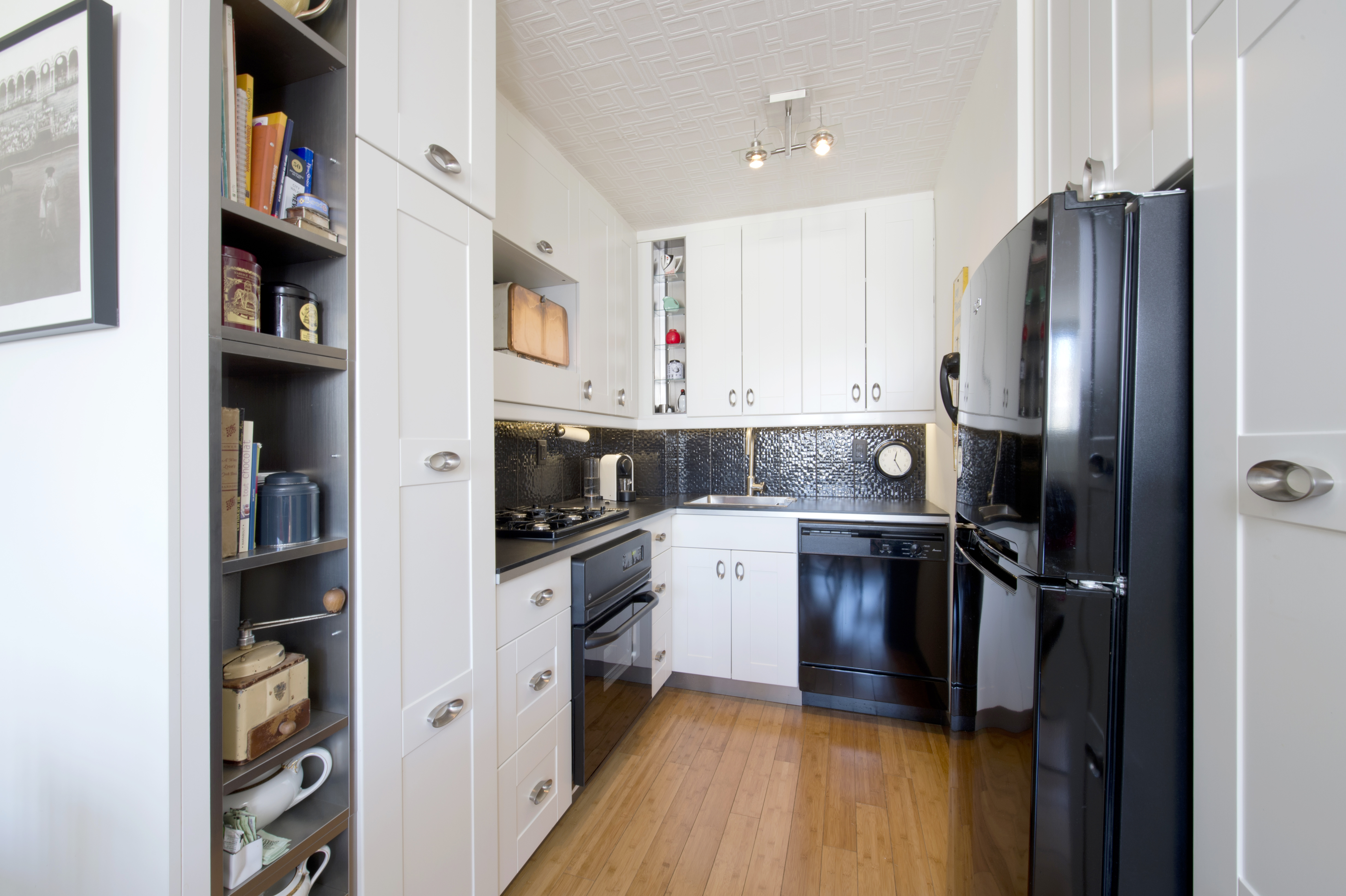 301 West 110th Street, Unit 7E Manhattan, NY 10026 - Photo 2 of 9 a kitchen with stainless steel appliances a refrigerator sink and cabinets