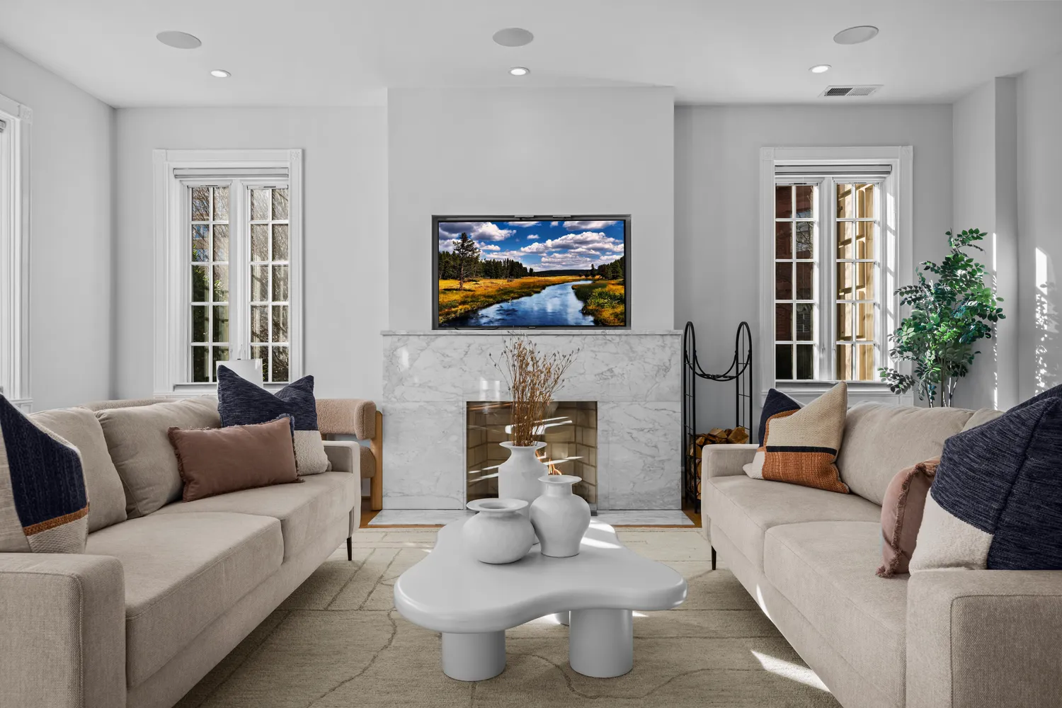 a living room with furniture a fireplace and a flat screen tv