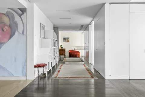 a view of living room with furniture and wooden floor