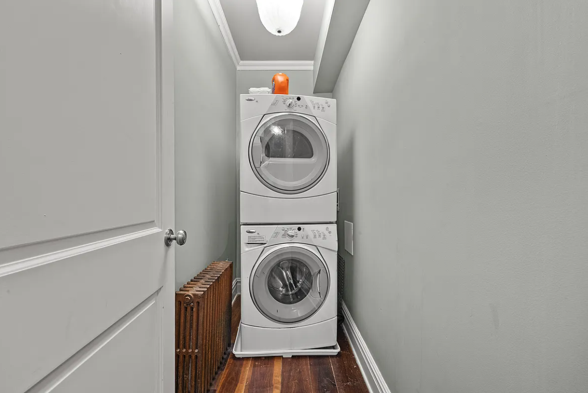 58 Downing Street Manhattan, NY 10014 - Photo 19 of 21 a utility room with dryer and washer