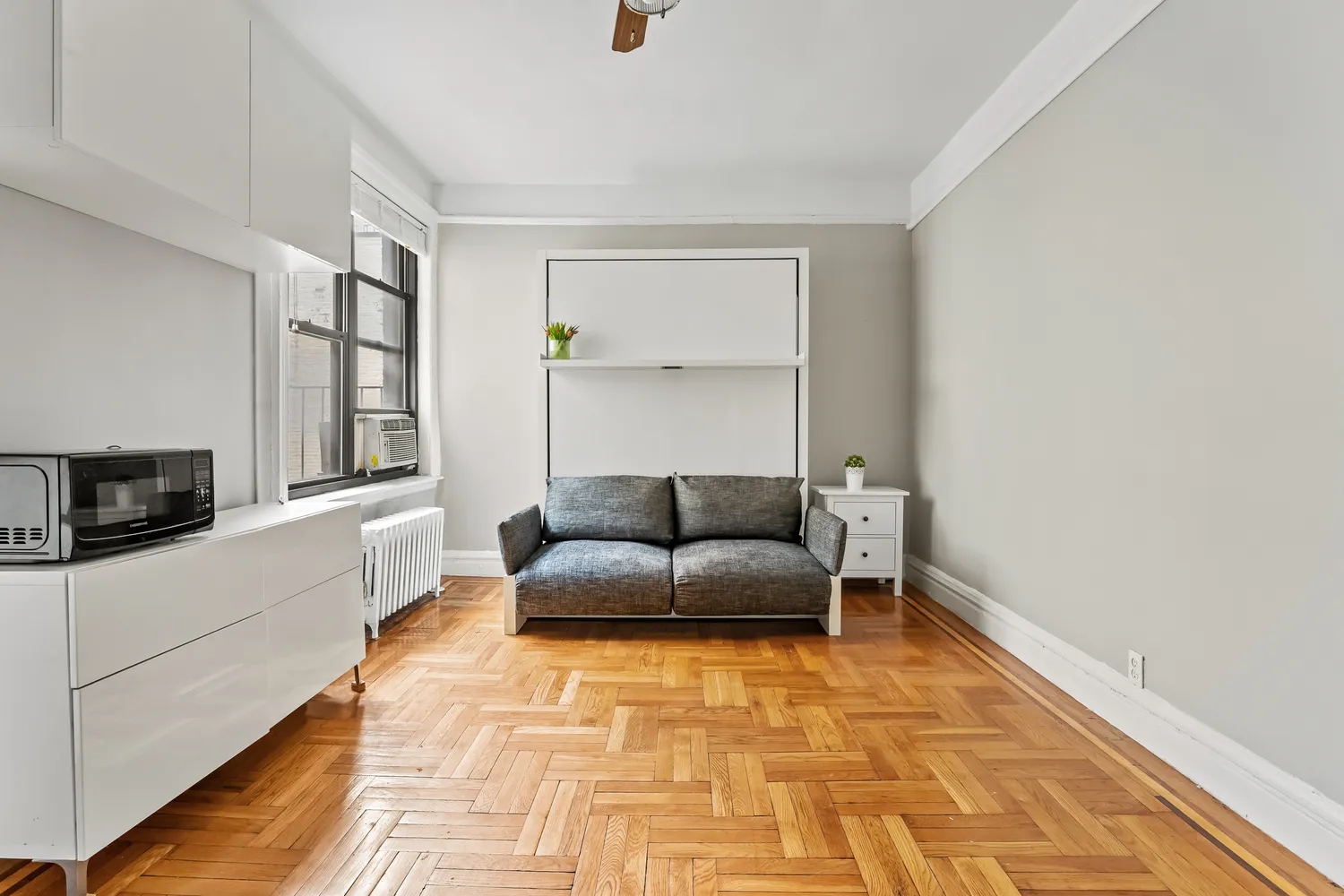 a living room with a couch and a rug