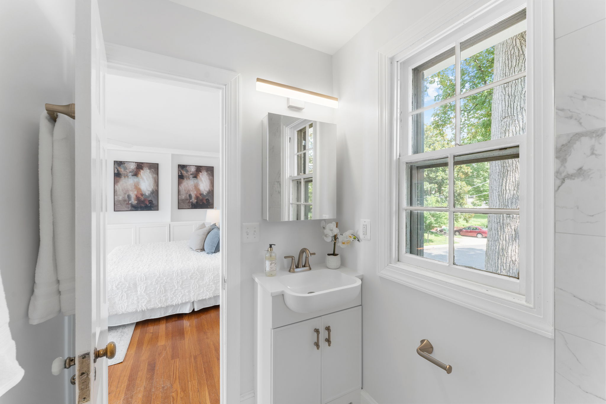 1325 Locust Road Northwest Washington, DC 20012 - Photo 31 of 56 a bathroom with a granite countertop sink a mirror and next to a window