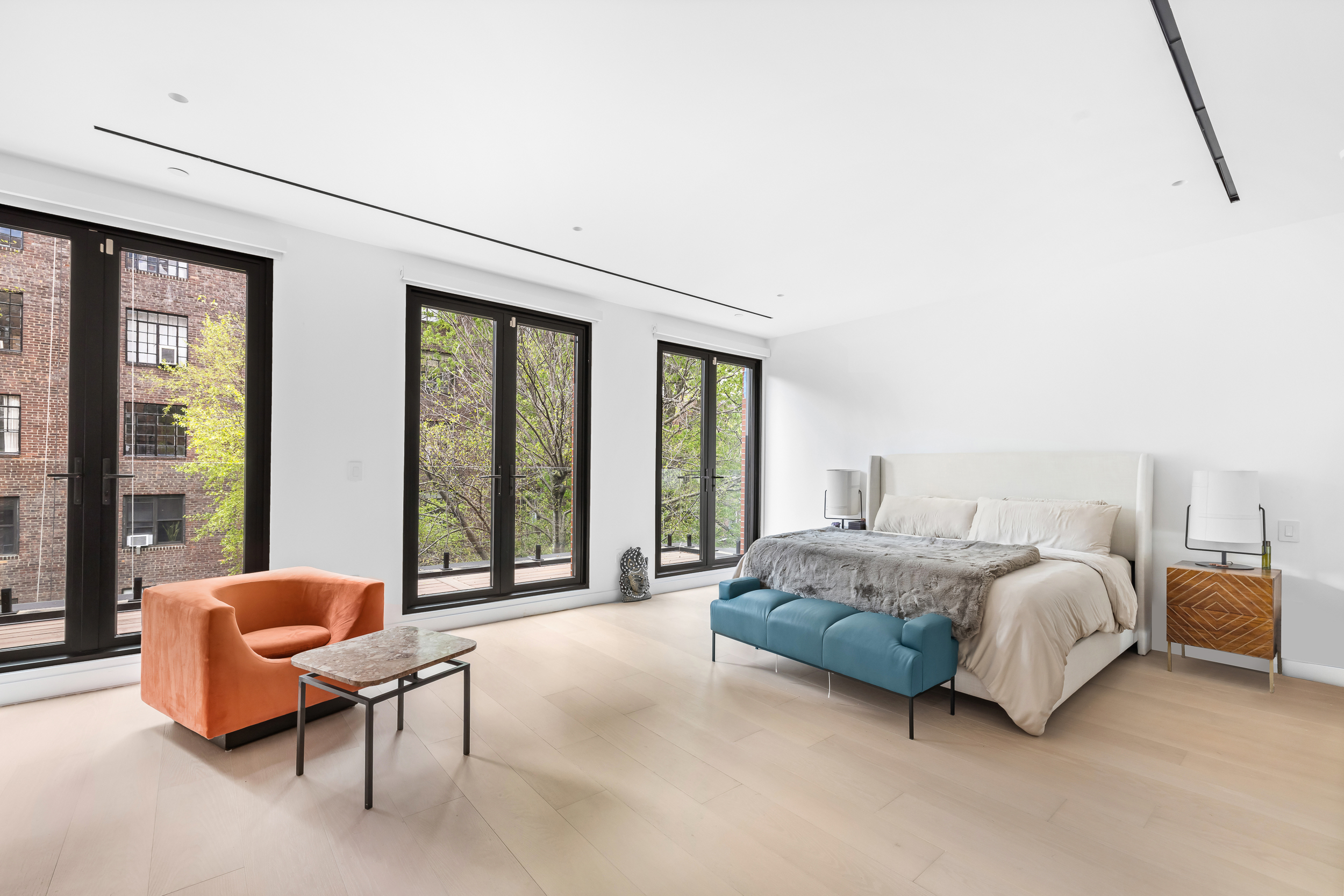 442 West 22nd Street Manhattan, NY 10011 - Photo 12 of 17 a spacious bedroom with a bed and large windows
