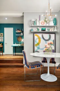 a room with furniture and painting on the wall