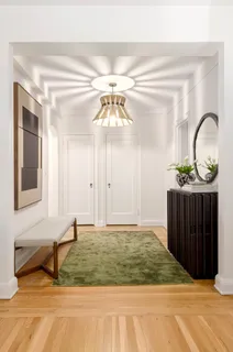 a view of a room with a sink and mirror